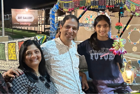 Family portrait at a fair with colorful lights